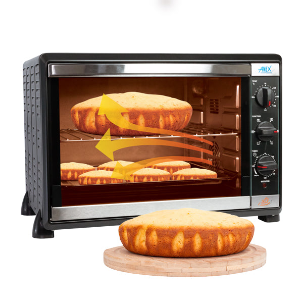 Anex Oven Toaster AG-2070 with baked goods inside, accompanied by a cake on a wooden board.