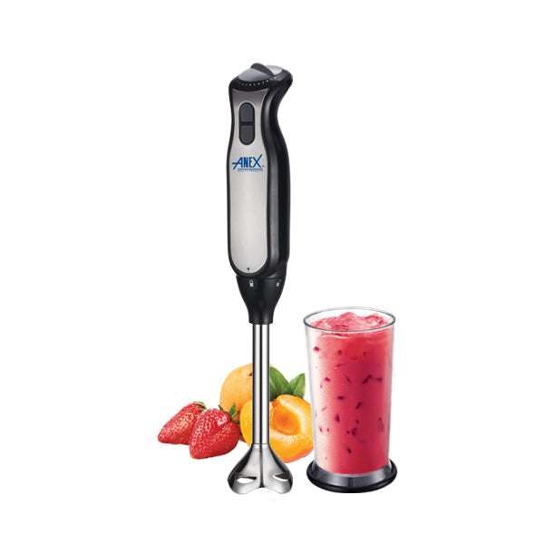 Hand blender with a glass of pink smoothie, strawberries, and apricots on a white background